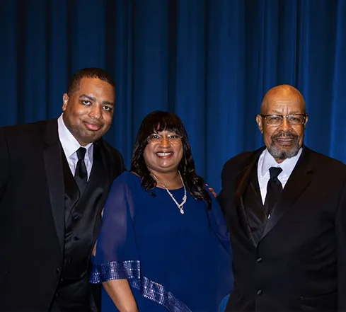 Lonnie with his parents in formal attire