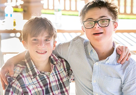 two young best buddies participants with their arms over each others shoulders