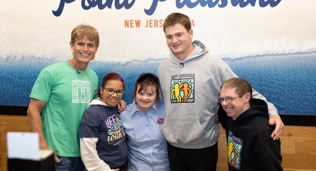 Anthony Kennedy Shriver, Best Buddies participants, and Drake Maye pose together at Jersey Mike’s in Point Pleasant, New Jersey, highlighting the partnership and support for the Best Buddies program.