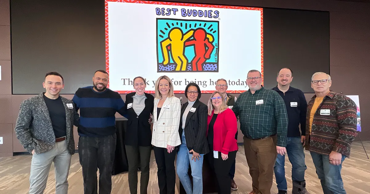 Group of event attendees smiling on stage