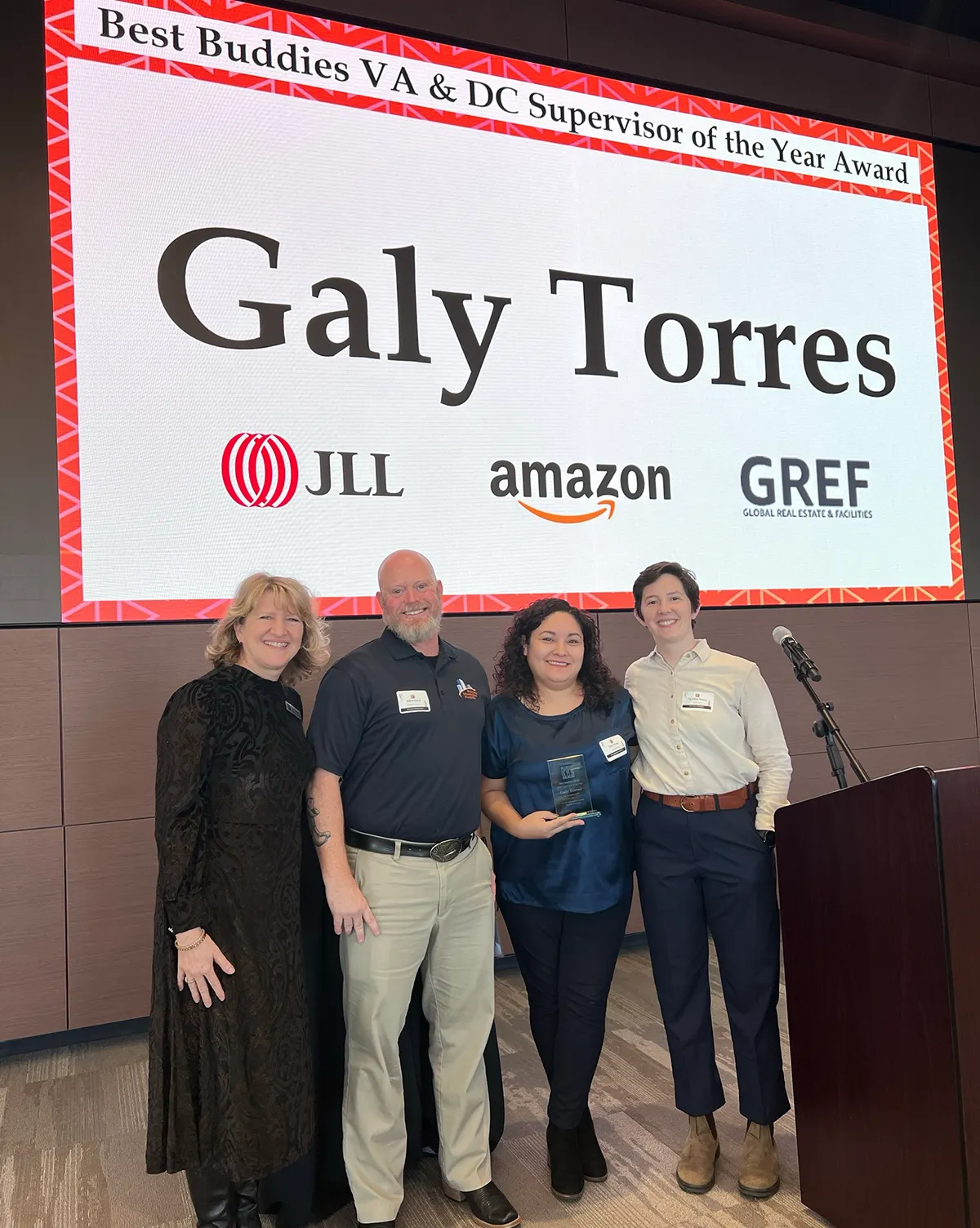 Group of Galy Torres employees on stage